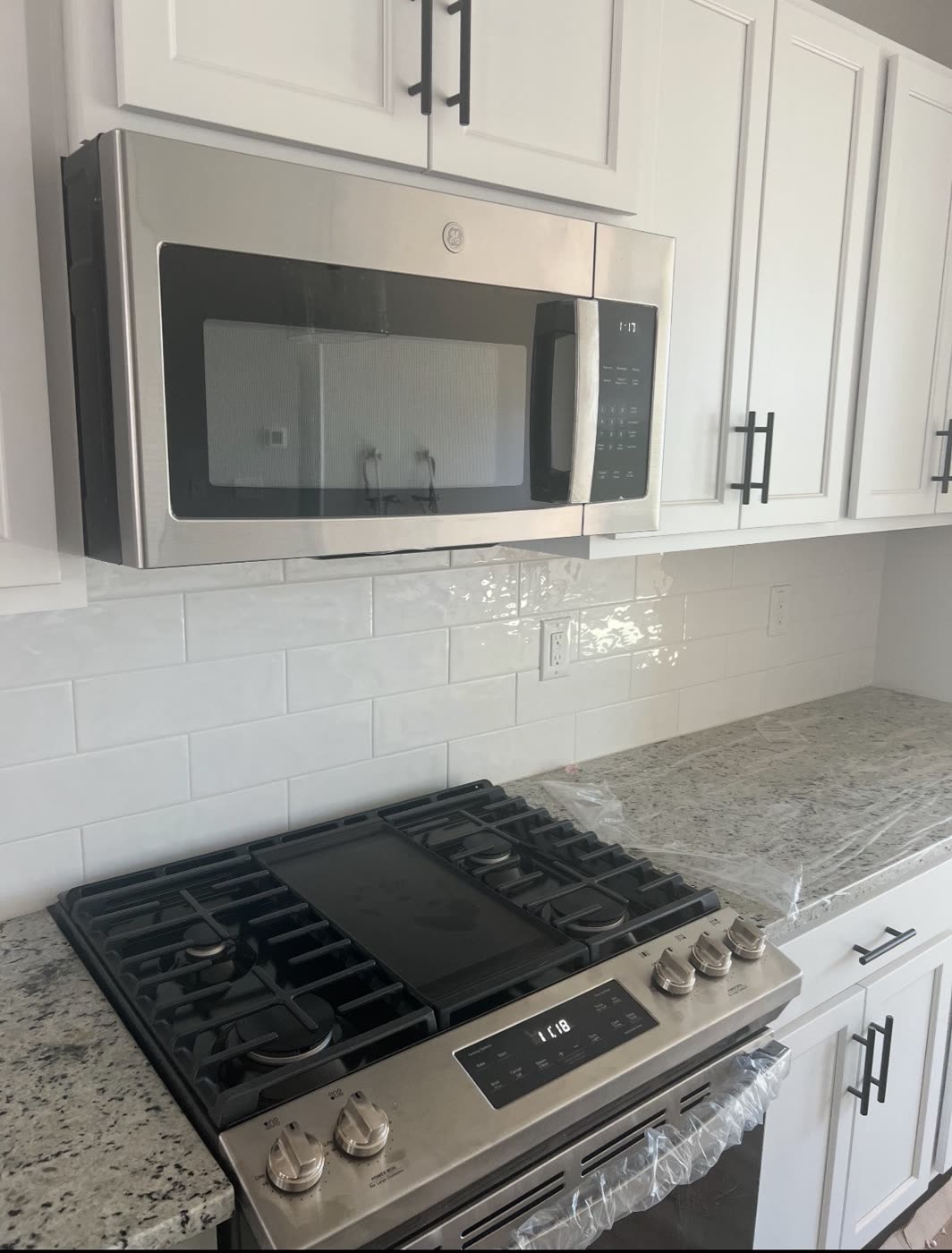 Range and over-range microwave installed by AM&J
